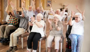 residents sitting in chairs clapping